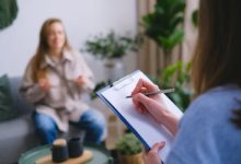 A doctor providing a note for work absence to help a parent navigate school and work requirements.