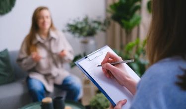 A doctor providing a note for work absence to help a parent navigate school and work requirements.